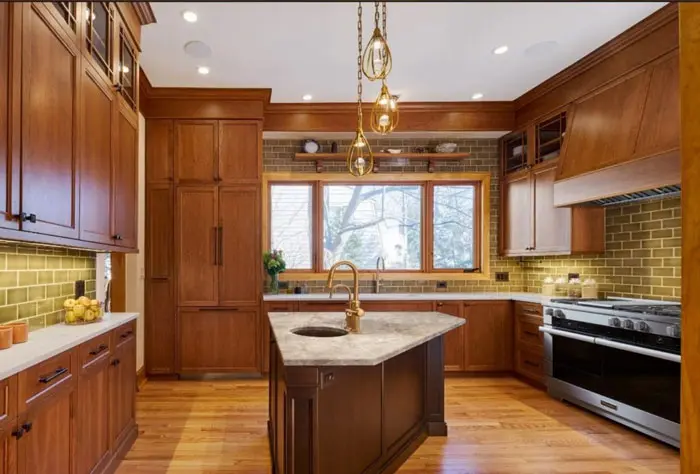 Modern kitchen remodel by home remodelers in Evanston, IL, featuring wood cabinetry and a marble island