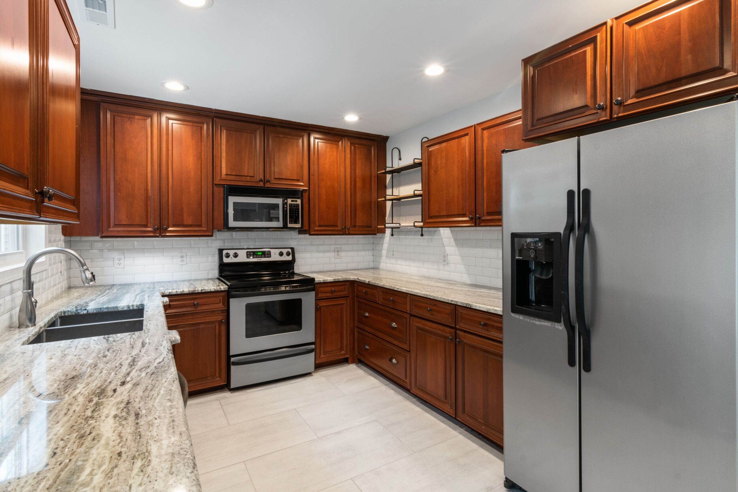 July Kitchen Remodeling in Chicago: Heat, Permits & Timeline 2 Elegant kitchen interior featuring wooden cabinetry and stainless steel appliances.